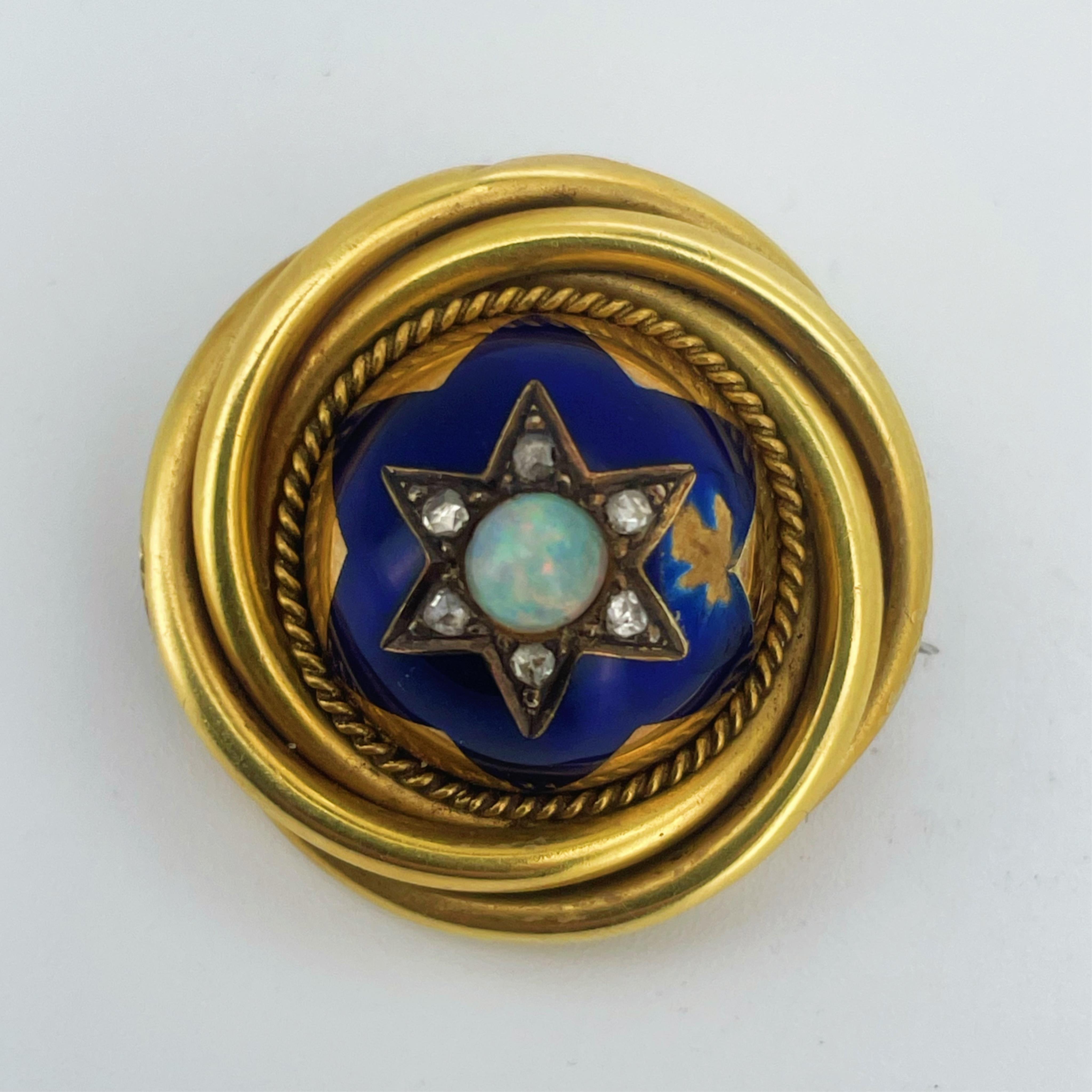 A Victorian gold, enamel, opal and diamond brooch, mid 19th century, of circular outline, the domed centre set with a cabochon opal surrounded by rose-cut diamonds, within a six-rayed star motif in blue enamel, to a bord